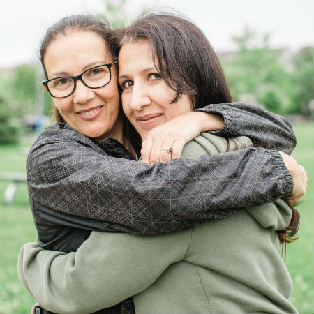 Daniela and Patricia hugging in a park